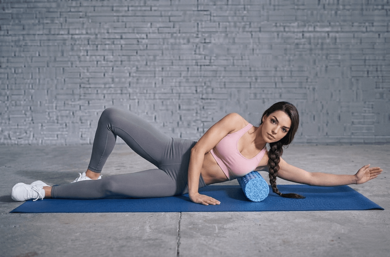 Fit woman foam rolling the lats